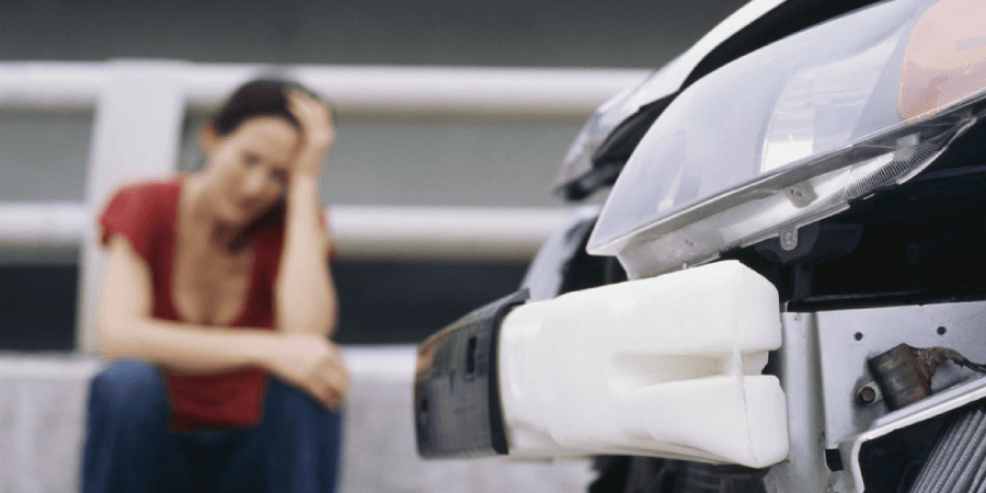 Woman Holding Head After Car Crash