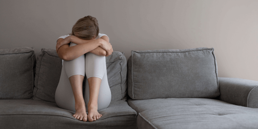 Stressed Woman On Sofa