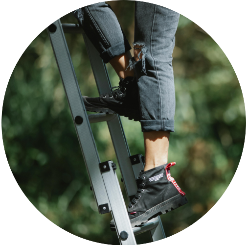 Woman Climbing Up Ladder