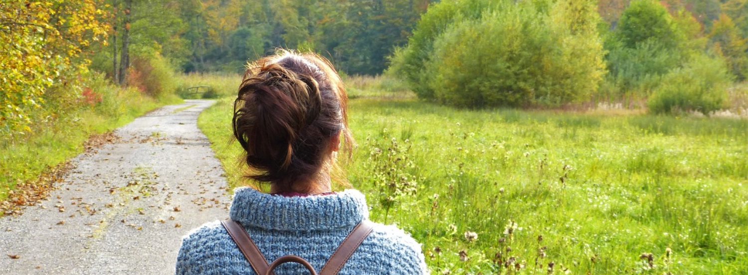 Woman Walking Along Path
