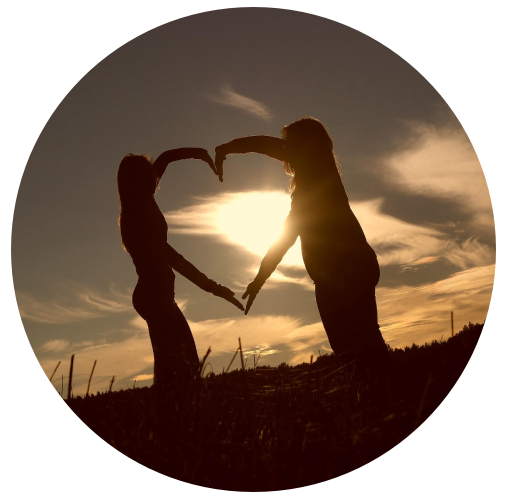 Couple making a heart shape with their arms