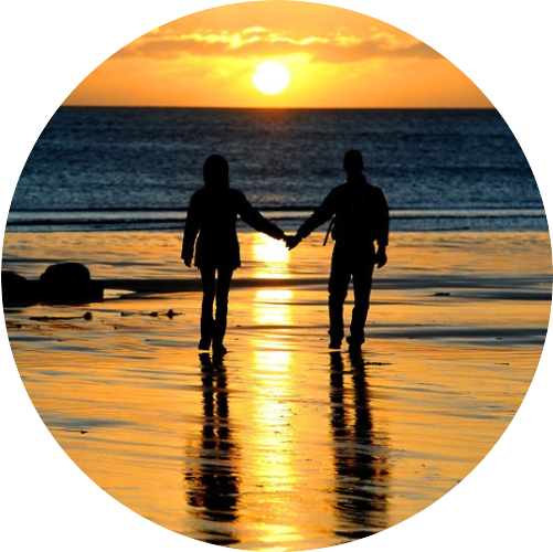 Couple Holding Hands On The Beach