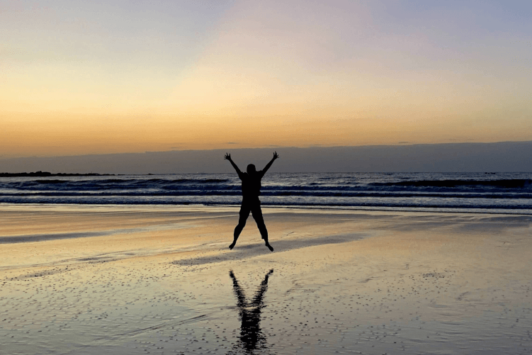 Happy Man Jumping On Beach