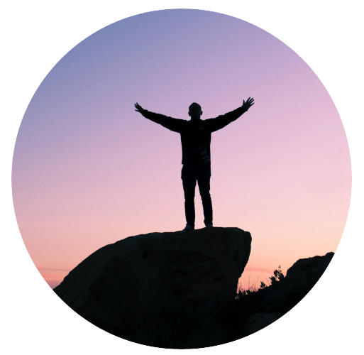 Man Standing On Rock Celebrating