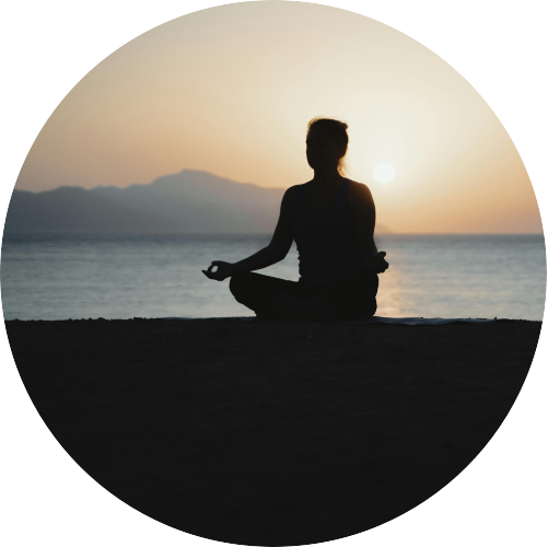 Woman Meditating On The Beach