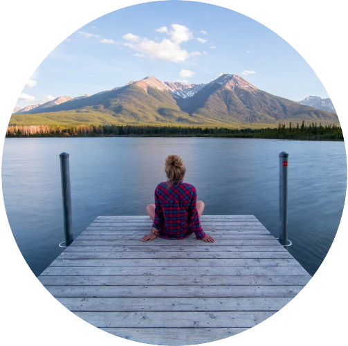 Woman Sitting On A Jetty