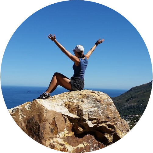 Woman Sitting On Rock Celebrating