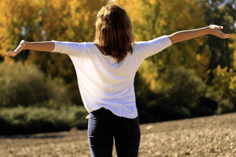 Happy Woman With Arms Outstretched