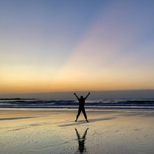 Happy Man Jumping On Beach