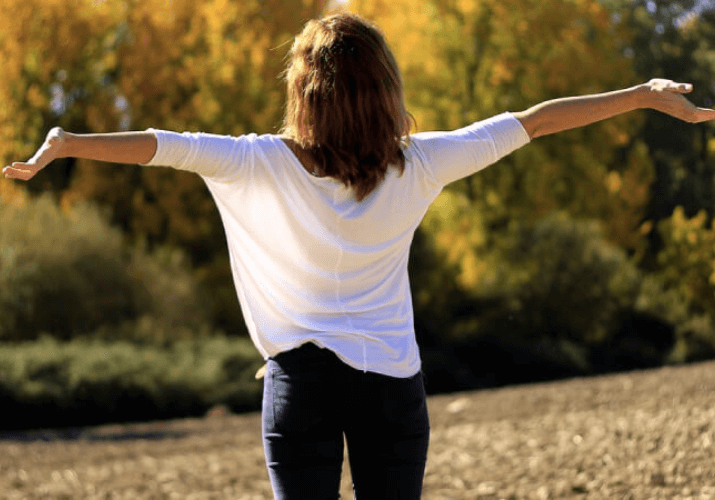 Happy Woman With Arms Outstretched
