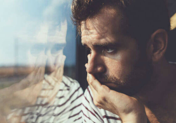 Depressed Man looking out of the window
